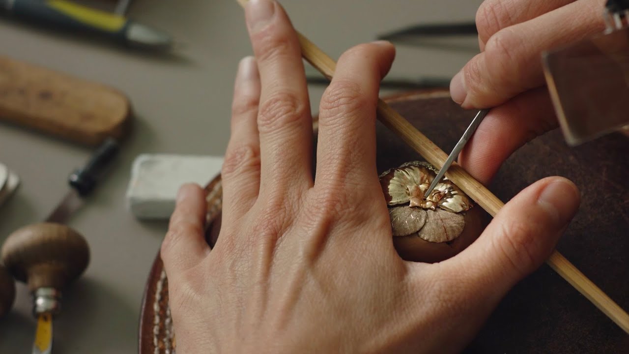 A Buccellati engraver hand-engraving gold with a burin