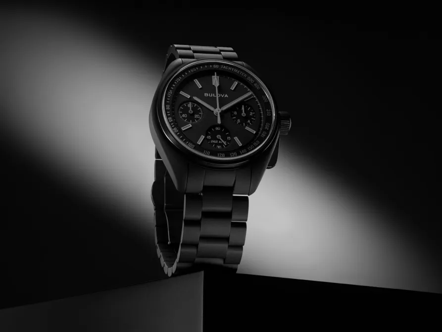 Bulova Lunar Pilot Black Hole dial close-up — Musou Black surface, grey Super-LumiNova indices, gun-metal tachymeter scale
