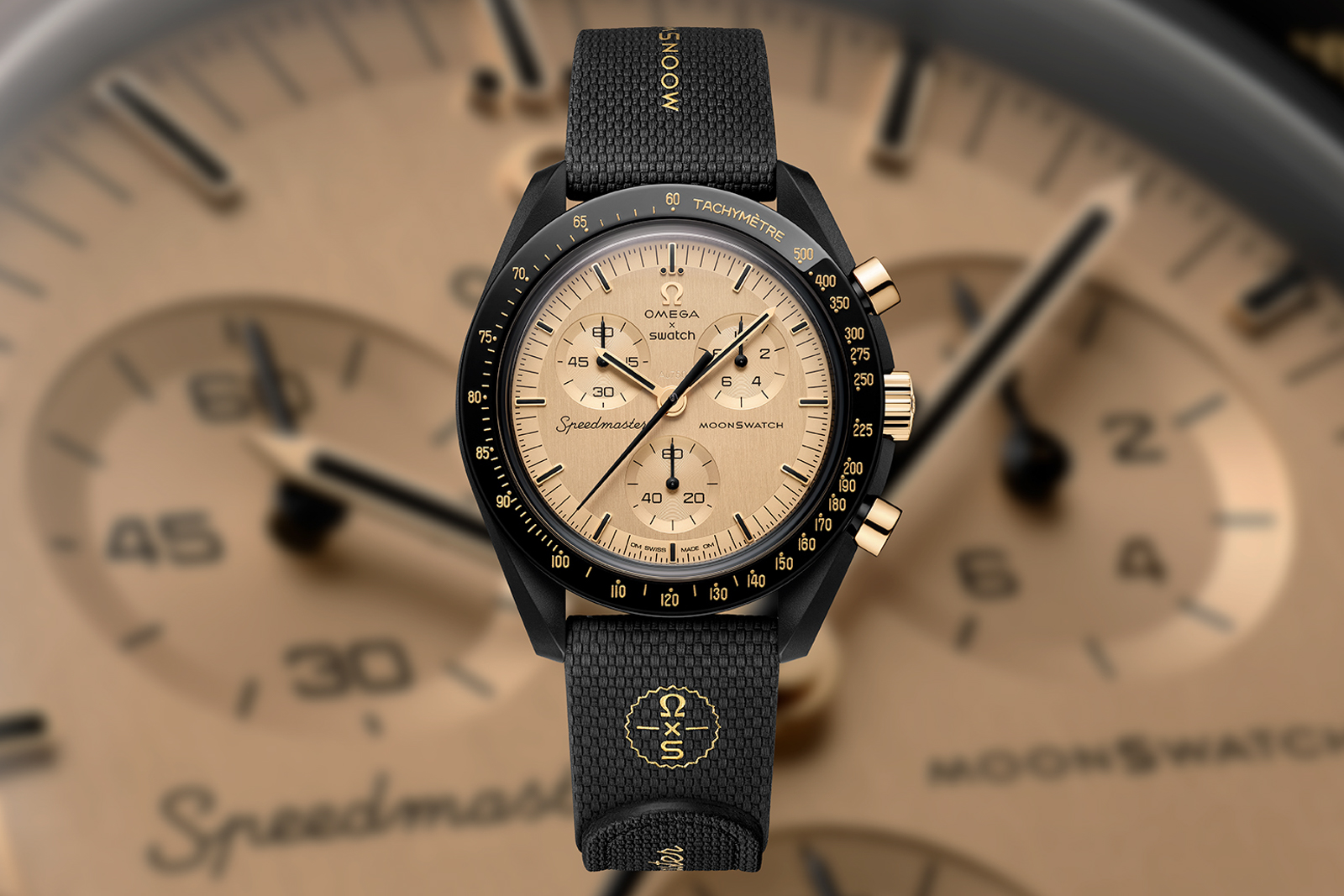 MoonSwatch Mission to the Moon 1969 — full product shot showing black Bioceramic case and MoonShine Gold dial with tachymeter bezel