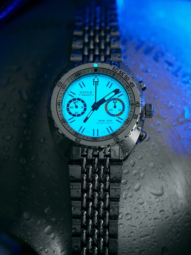 Doxa SUB T.Graph II Great White Topper Edition glowing in the dark — fully luminous BGW9 Super-LumiNova creating brilliant neon glow across entire dial