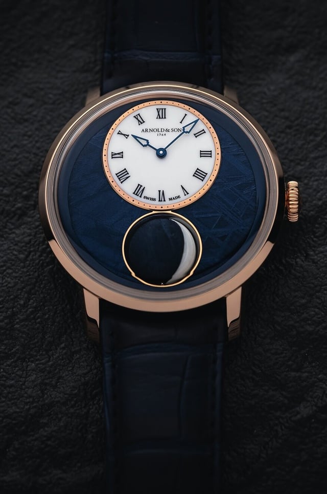 Arnold & Son Luna Magna — 44mm red gold case with meteorite and aventurine dial, 3D spherical marble moon rotating in PVD display, largest 3D moonphase on a wristwatch