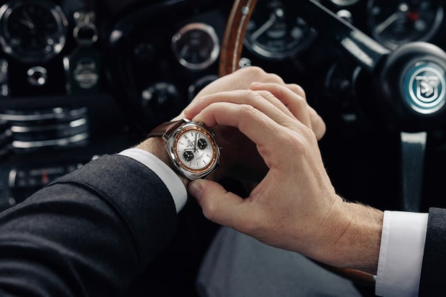 Breitling Top Time Aston Martin DB5 steel edition on wrist — 41mm cushion case, silver sunray dial, real wood rehaut, brown gradient calfskin strap