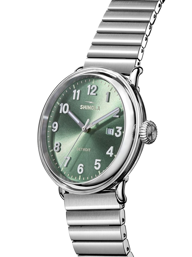 Shinola Detrola Cypress Green 2026 side view — deep green sunray dial with matte alabaster numerals and brushed silver metal bracelet on transparent TR90 case