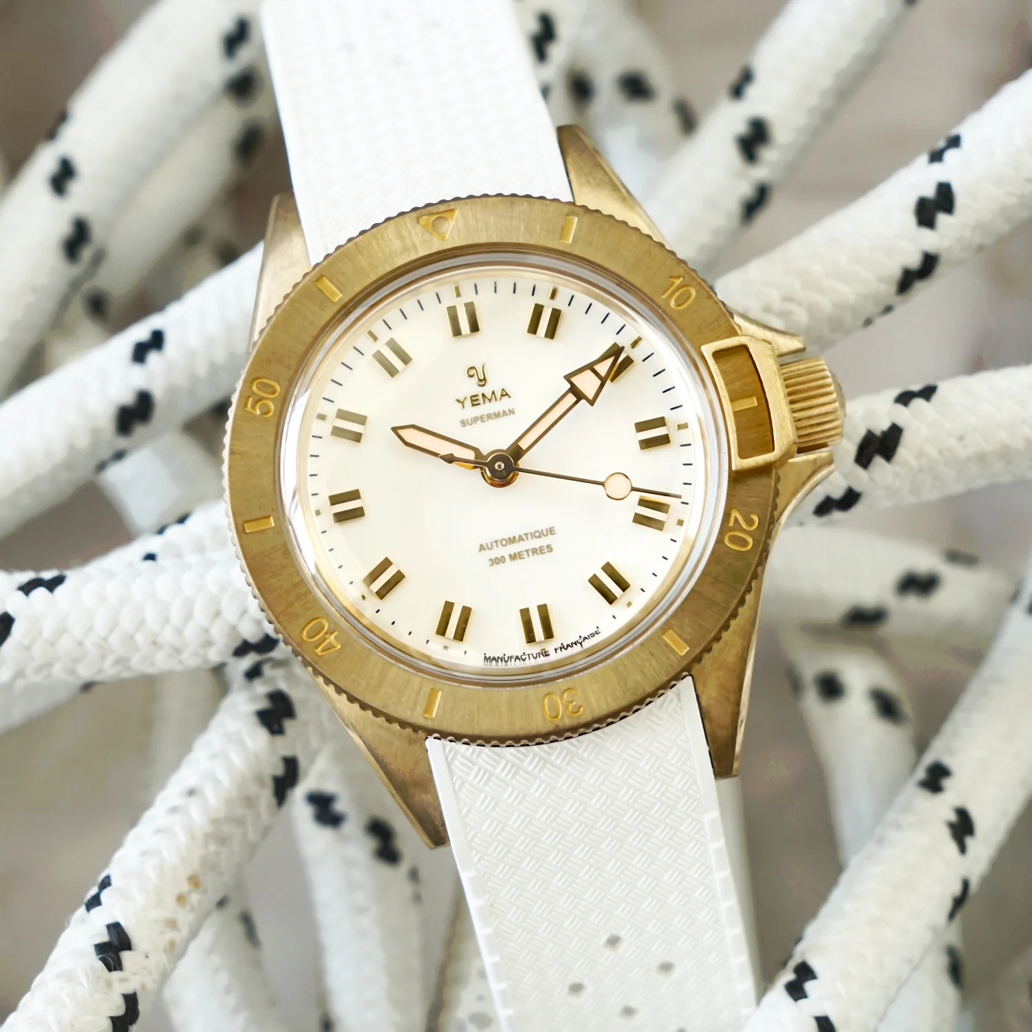 Yema Superman Bronze CMM.10 white dial — glossy white lacquered dial with gilt applied markers and diamond-cut hands, bronze case showing patina warmth